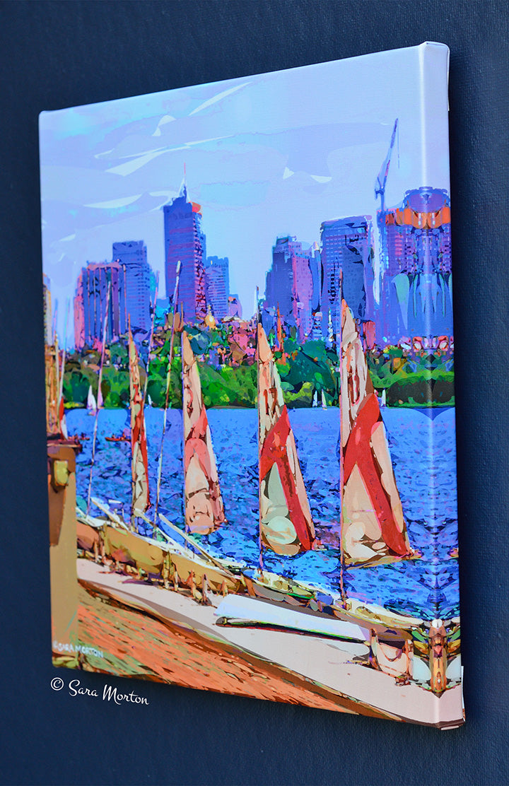 Sunset view of MIT Sailing Pavilion sailboats with red and white sails glowing in the warm light. Right Side view of Stretched Canvas Print.