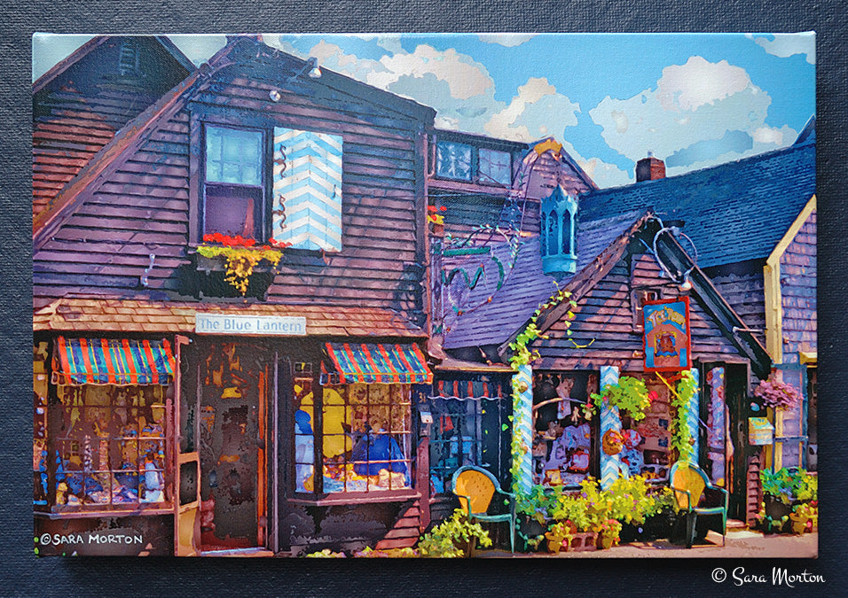 A stretched canvas print depicting the exterior of 'The Blue Lantern' gift shop in Rockport, Massachusetts, Bearskin Neck, featuring a rustic wooden building with a visible sign and flower boxes.
