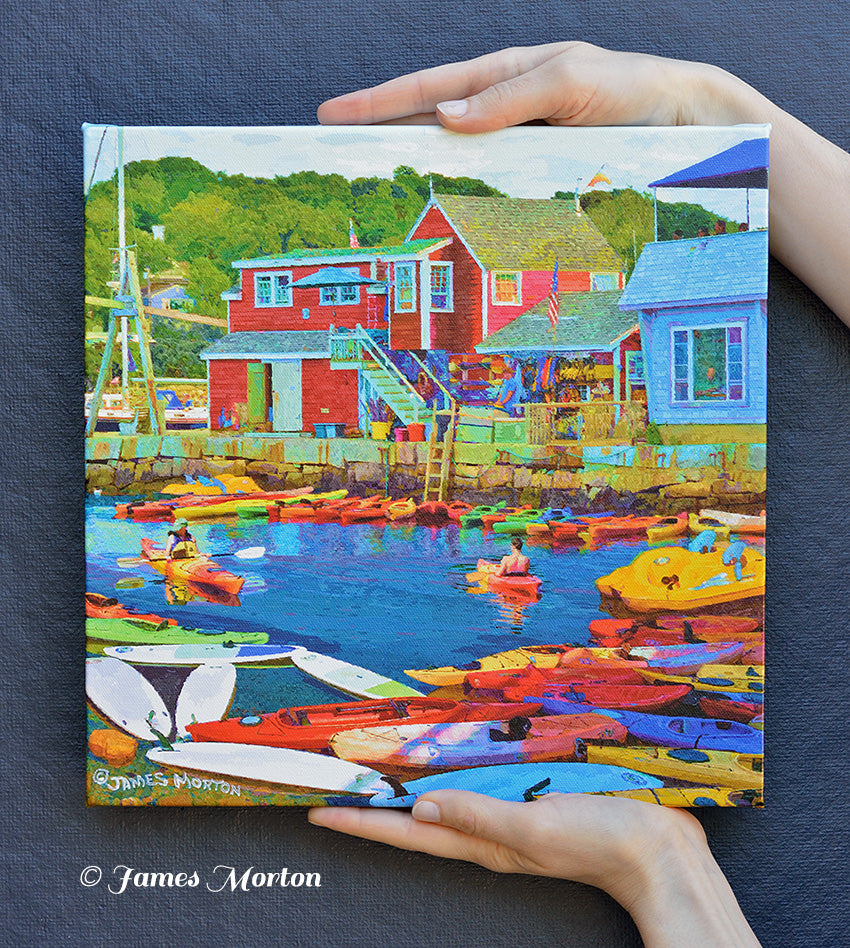Rockport MA Kayaks in Bearskin Neck, Massachusetts - canvas print 12in x12in Handheld front of picture, providing a sense of scale and showcasing the vibrant harbor scene.
