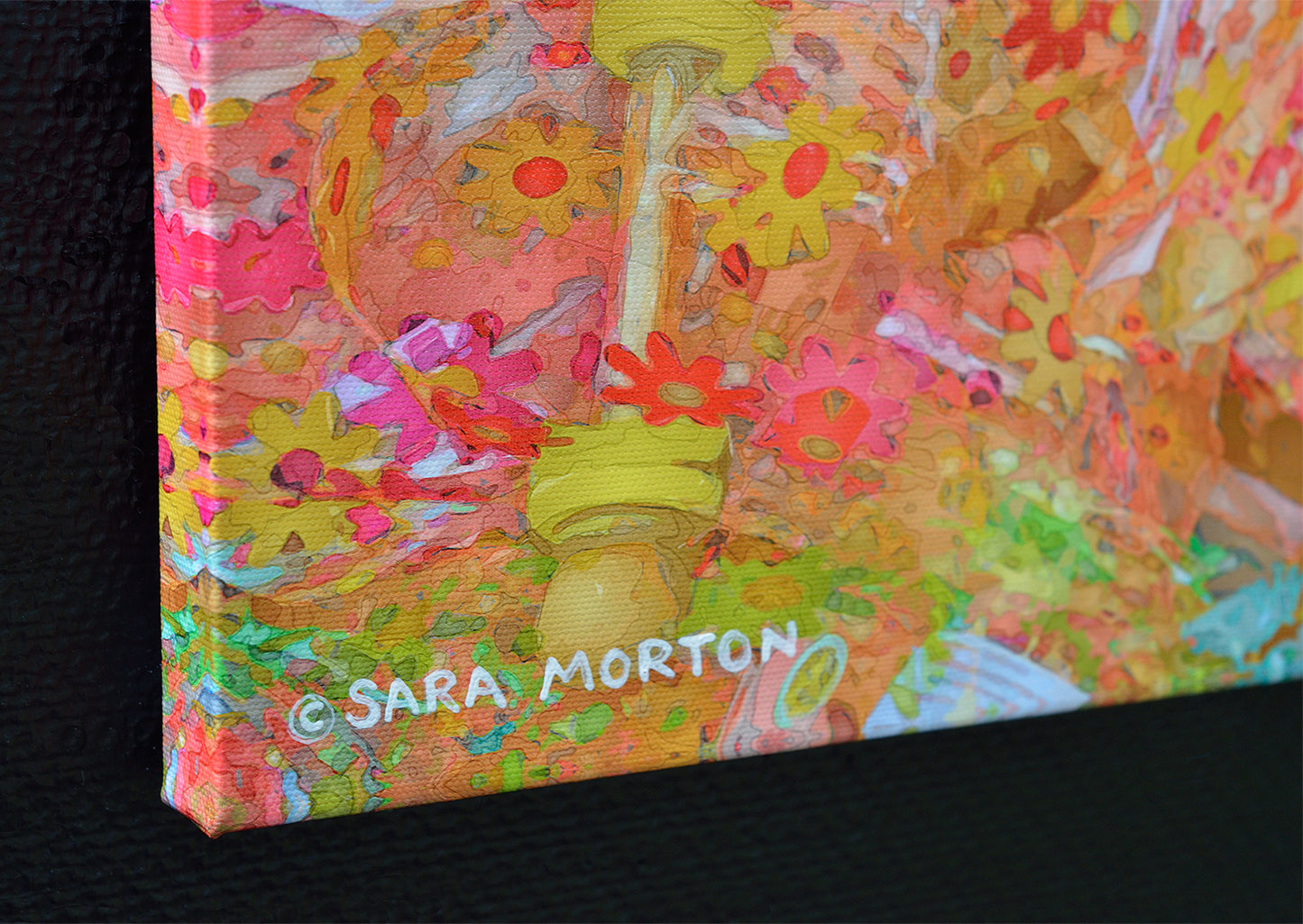 Colorful abstract artwork on canvas with floral patterns detail of left corner with Sara Morton's painted signature.
