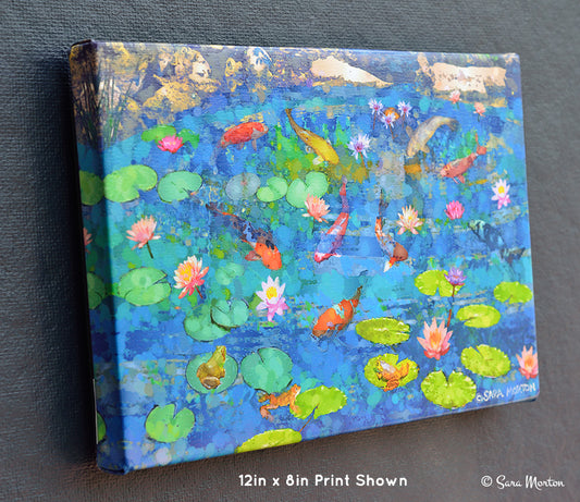 Canvas print of a pond scene with koi fish and lily pads. Left side view of 12in x 8in stretched canvas print with image wrapped edge.