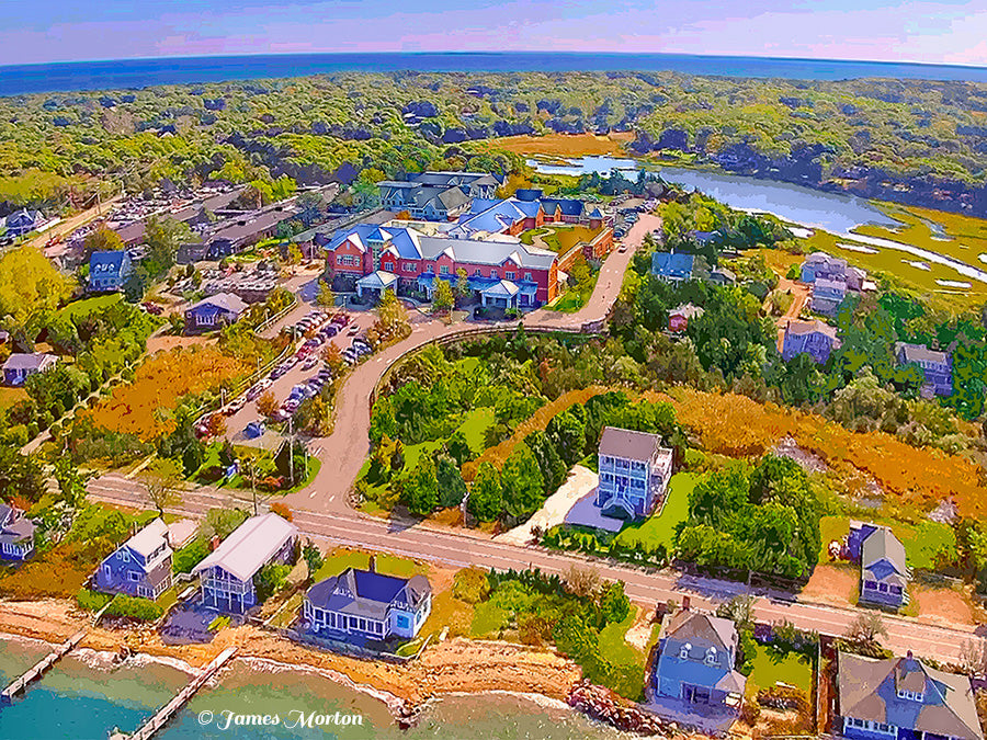 Aerial fine art print of Martha’s Vineyard Hospital in Oak Bluffs, featuring neighboring  homes, coastal landscape, lush trees, Brush Pond, and a soft lavender sky over the Atlantic Ocean.
