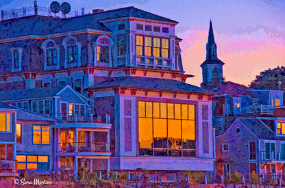 A vibrant fine art print featuring the Shalin Liu Performance Center in Rockport, Massachusetts at night with a warm glow of autumn light.