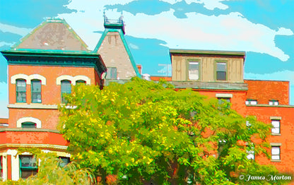 Close-up of upper mill buildings at Baker’s Chocolate Mills, historic red brick rooftops and chimneys overlooking the Neponset River in Dorchester Lower Mills.
