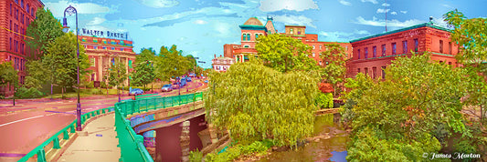 Panoramic cityscape art print of Baker's Chocolate Square in Lower Mills, Milton MA, showing the historic chocolate factory buildings, Adams Street bridge, and surrounding trees.
