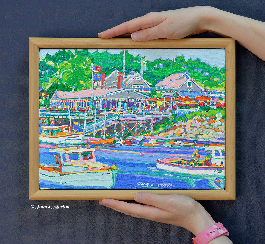 Original Ogunquit, Maine acrylic painting held by hand for scale, featuring Perkins Cove, Barnacle Billy's restaurant, colorful fishing boats, and a finished pine wood frame.