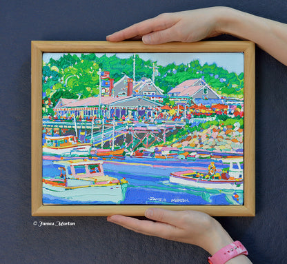 Original Ogunquit, Maine acrylic painting held by hand for scale, featuring Perkins Cove, Barnacle Billy's restaurant, colorful fishing boats, and a finished pine wood frame.
