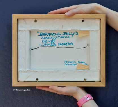 Back of framed original acrylic painting on canvas titled Barnacle Billy's, depicting Perkins Cove in Ogunquit, Maine. Hand signed, titled, labeled by the artist, wired and ready to hang, shown held for scale.