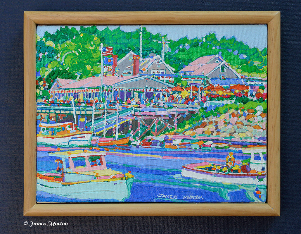 Framed original Ogunquit, Maine acrylic painting of Perkins Cove featuring Barnacle Billy's restaurant, fishing boats, calm harbor water, and lush green trees in a natural pine wood frame.