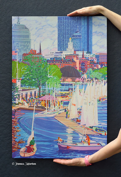Hand-held view of a ready-to-ship Boston skyline canvas print featuring Community Boating sailboats, the Charles River, John Hancock Tower, the Berkeley Building, and the New England Mutual Life Insurance Building.

