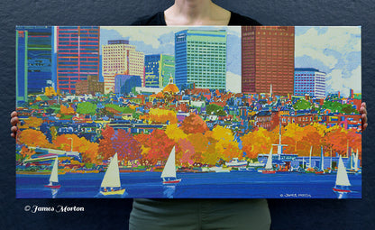 Person holding a 36 × 18 Boston skyline canvas print featuring Beacon Hill, the Charles River, Community Boating, and brilliant New England fall foliage for size reference.
