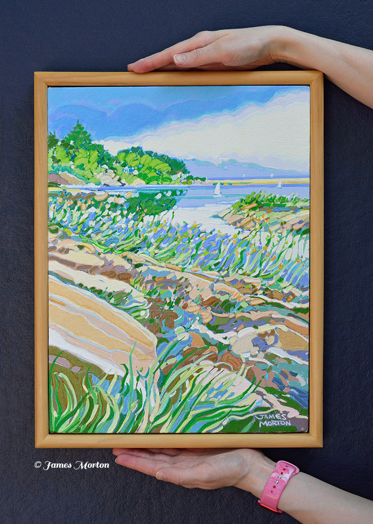 Ocean Pond original Ogunquit, Maine acrylic painting held by hand for scale. Framed 12 x 16 coastal landscape featuring the Marginal Way, rocky shoreline, sailboats, and tranquil Atlantic waters.