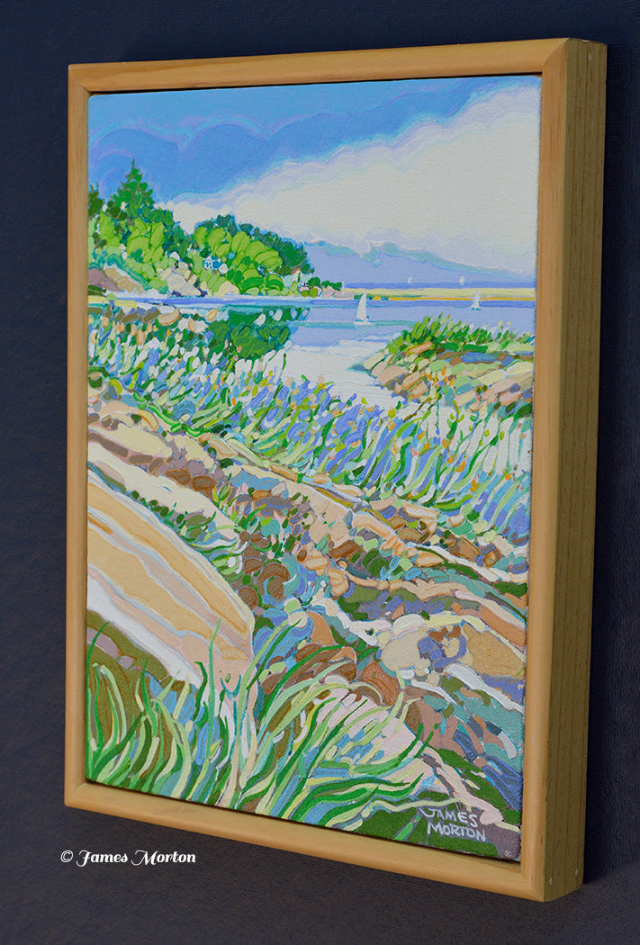 Right angle view of Ocean Pond original acrylic painting by James Morton showing Ogunquit's Marginal Way, Maine coastal rocks, beach grasses, distant sailboats, and light wood gallery frame.