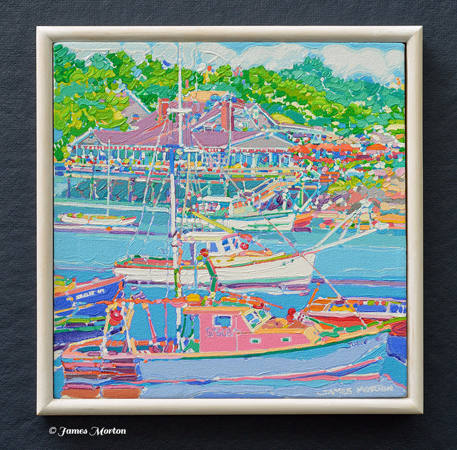 Original acrylic painting of Ogunquit Maine with fishing boats in the harbor of Perkins Cove. Barnacle Billy's Restaurant is seen in the background surrounded by lush green trees. 