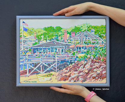 Original acrylic painting on linen held for scale, featuring Perkins Cove in Ogunquit, Maine with Barnacle Billy's restaurant, a white rowboat, rocky shoreline, and coastal trees in a finished pine wood frame.
