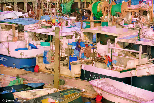 A tranquil yet active scene at Scituate Harbor’s fishing pier in Massachusetts. Scituate Fishers Four features a striking arrangement of fishing boats in white and neutral tones. 